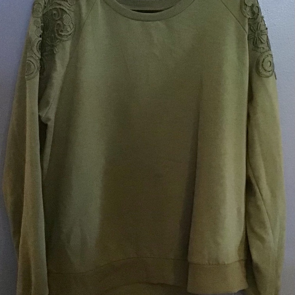 Green crew neck sweater with cutouts on the sleeves